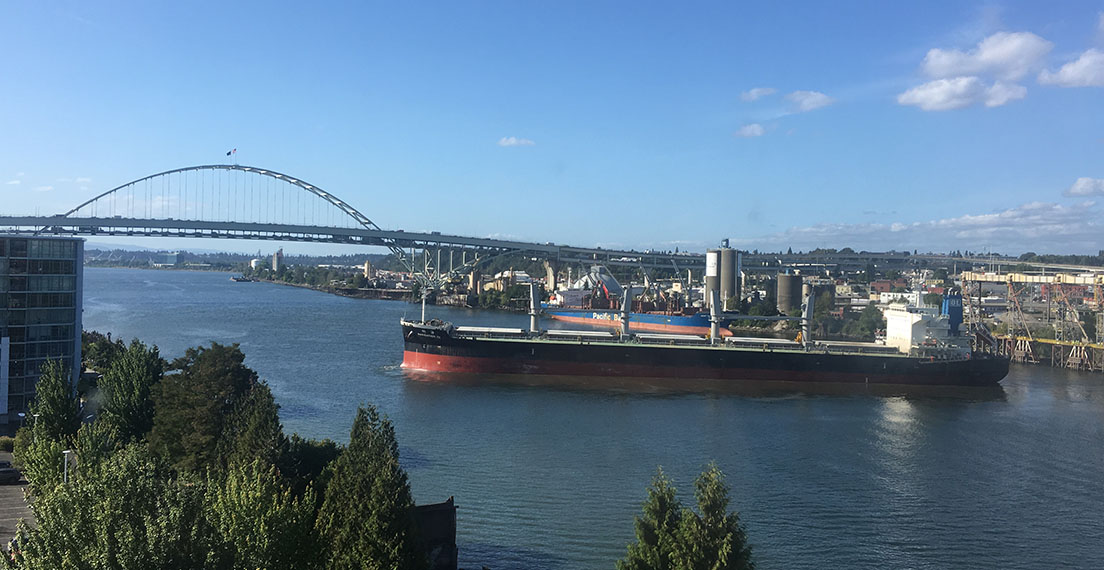 Image of a dry bulk freight vessel departing an export elevator loaded with wheat for overseas markets