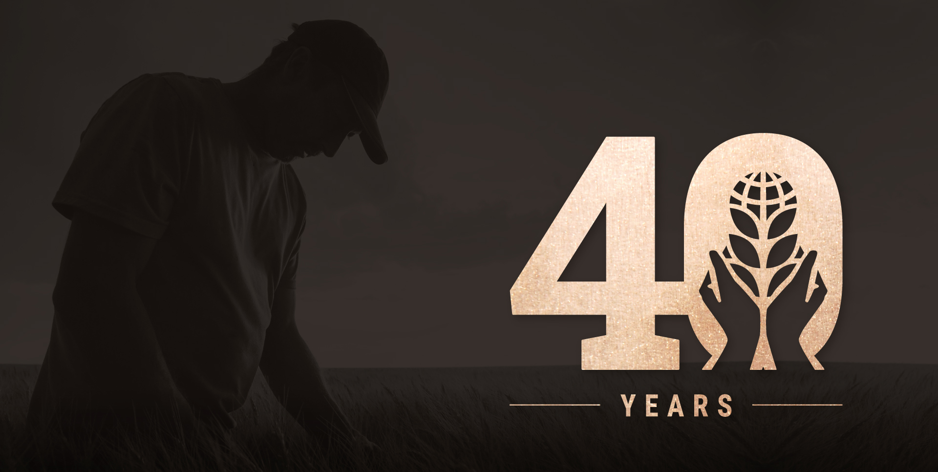 Man in wheat field with U.S. Wheat Associates 40th Anniversary Logo