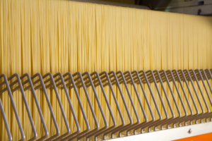 Image shows long goods pasta production in a commercial plant.