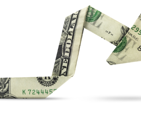 Image shows a folded US$ bill shaped like a price movement chart up and down and flat.