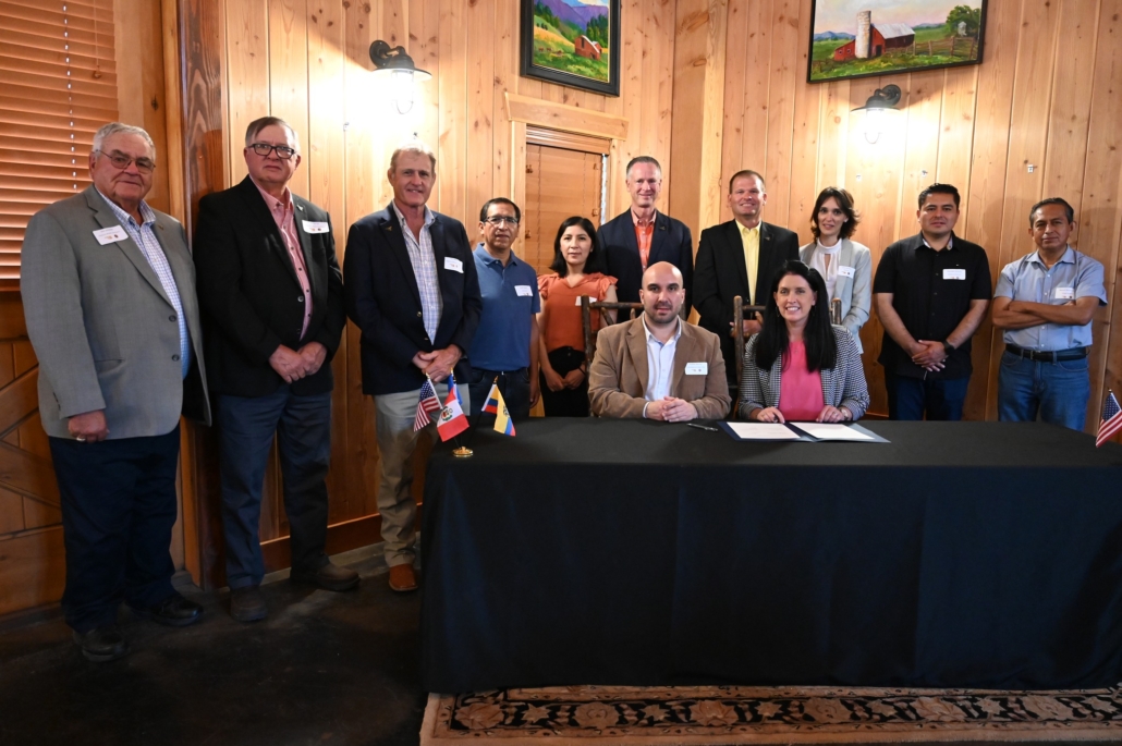 The Oklahoma Wheat Commission, USW and members of a trade team from Ecuador and Peru observing U.S. wheat production participate in a trade agreement signing ceremony.