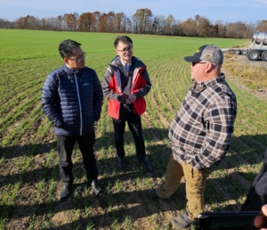 Ohio farmer Ray Van Horn talks with Chinese wheat buyers in his field planted with soft red winter wheat.