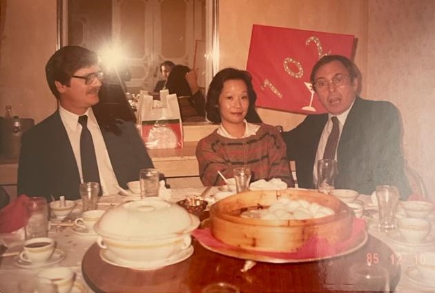Photo shows USW staff Rick Callies, Pansy Lam and Fred Schneiter at a dinner in China in 1985