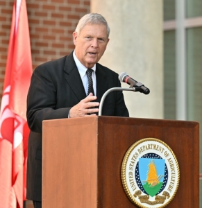 U.S. Secretary of Agriculture Tom Vilsack at a podium with the USDA seal addressing participants in a ground breaking ceremony for a new ARS Plant Sciences Building at Washington State University (WSU).