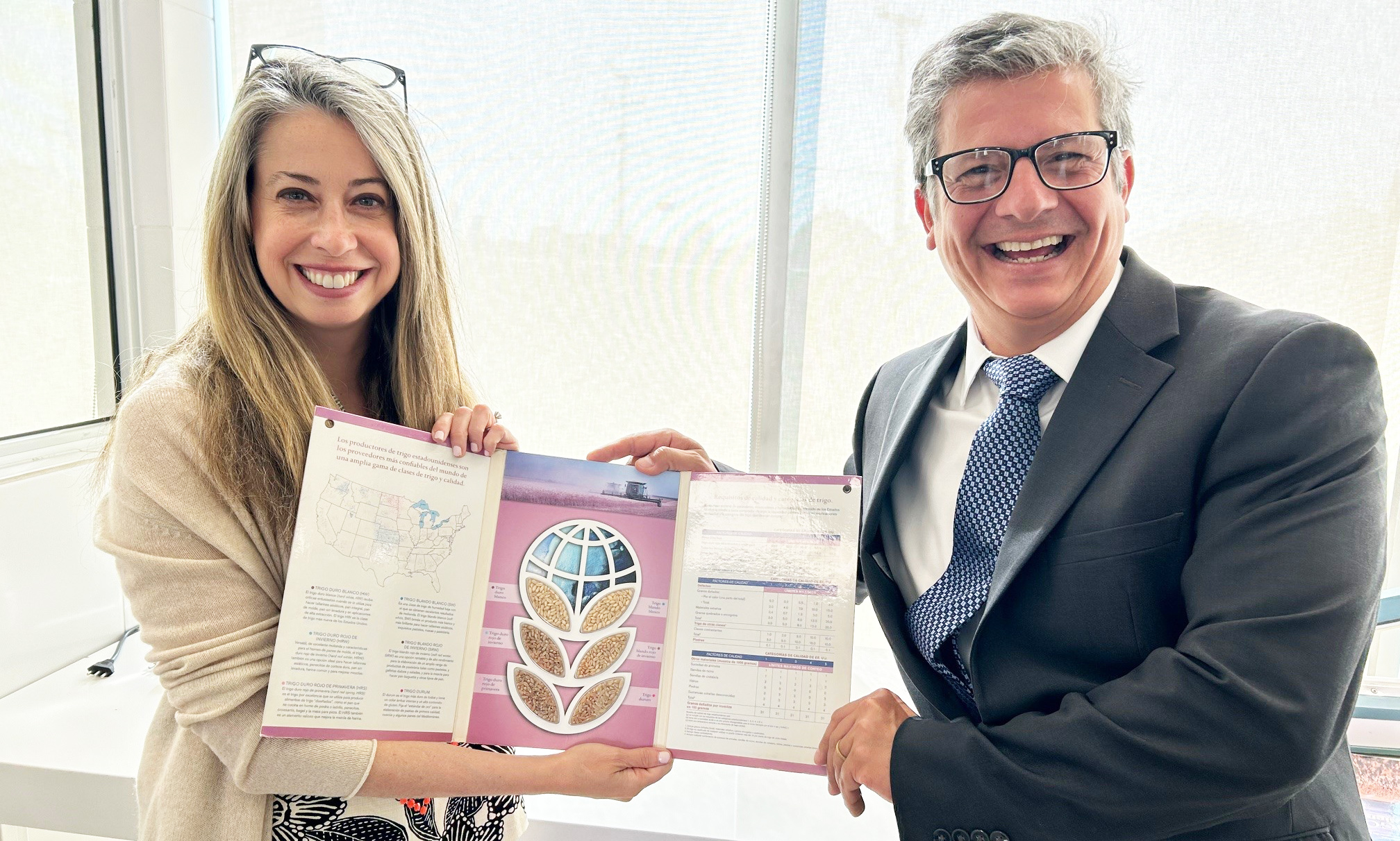 Galdos shares a U.S. wheat sample card with ambassador Meehan during discussions about the many uses for U.S. wheat and the preferences of end users in Chile.