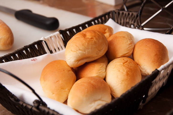White dinner rolls in a basket to illustrate bread as part of the Thanksgiving meal