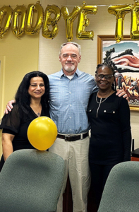 McGarry poses with USW's Planning and Administrative Assistant Nada Obaid, left, and Meeting Planner Stacy Meade during a reception honoring McGarry.