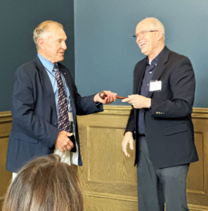 Ron Suppes, left, accepts the ceremonial gavel from outgoing Wheat Foods Council (WFC) Chairman Kent Juliot at the WFC Board Meeting in Denver on June 14.
