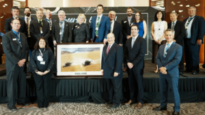 The USW team poses with one of the photos gifted by Past President Darren Padget to Filipino flour millers during the 60th anniversary celebration of the USW office in the Philippines.