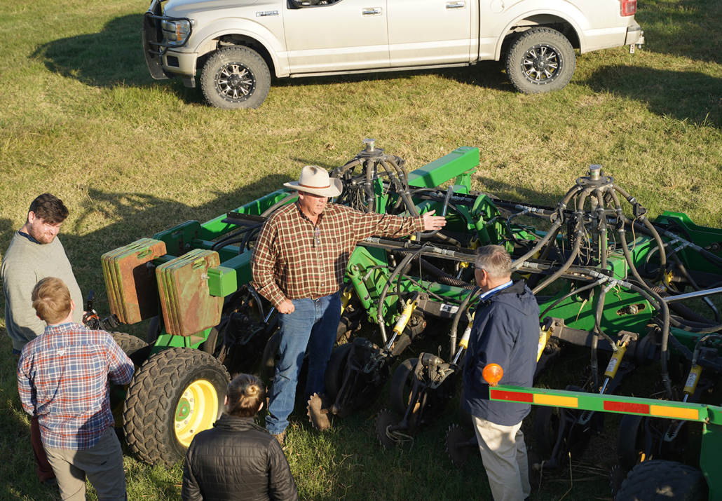 Tom Cannon explains the workings of his direct-seeding no-till drill to USW Vice President of Communications Steve Mercer and a film crew from USW's creative agency on hand to interview Cannon about how he practices sustainability on the farm.